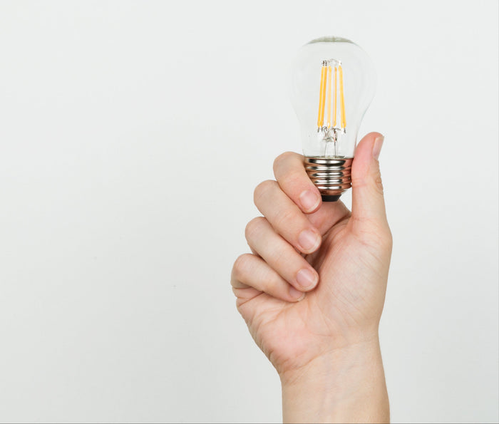 hand-with-lightbulb-on-white