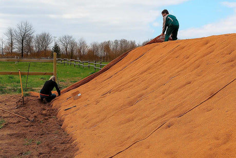 HEIGER coir blanket being installed on a hillside for soil erosion control and landscaping