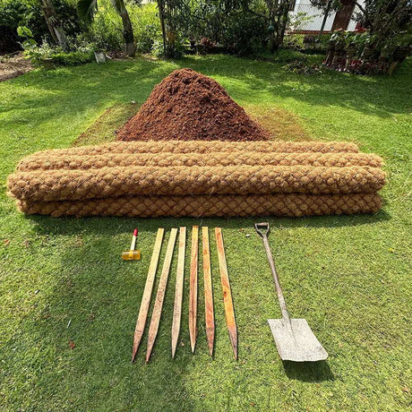 HEIGER wooden pegs with garden shovel and mulch rolls on green grass for landscaping
