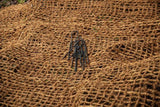 HEIGER black metal weed mat pins placed on brown natural fiber weed mat for garden use