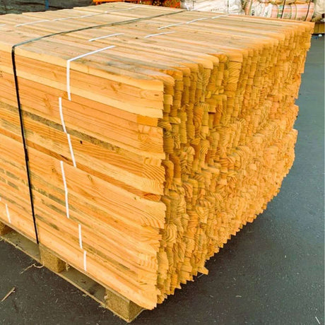 Stack of HEIGER wooden pegs bundled and secured on a pallet for construction use