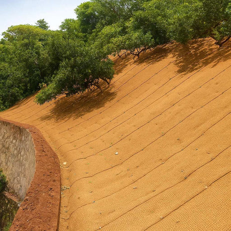 HEIGER coir blanket covering a large sloped outdoor area for erosion control with greenery in the background