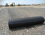 PP biaxial geogrid rolled out on construction site for soil stabilization and reinforcement