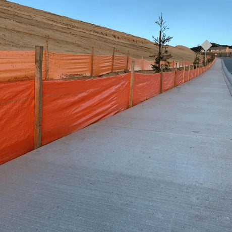 HEIGER orange silt fence installed along a sidewalk to control erosion and sediment