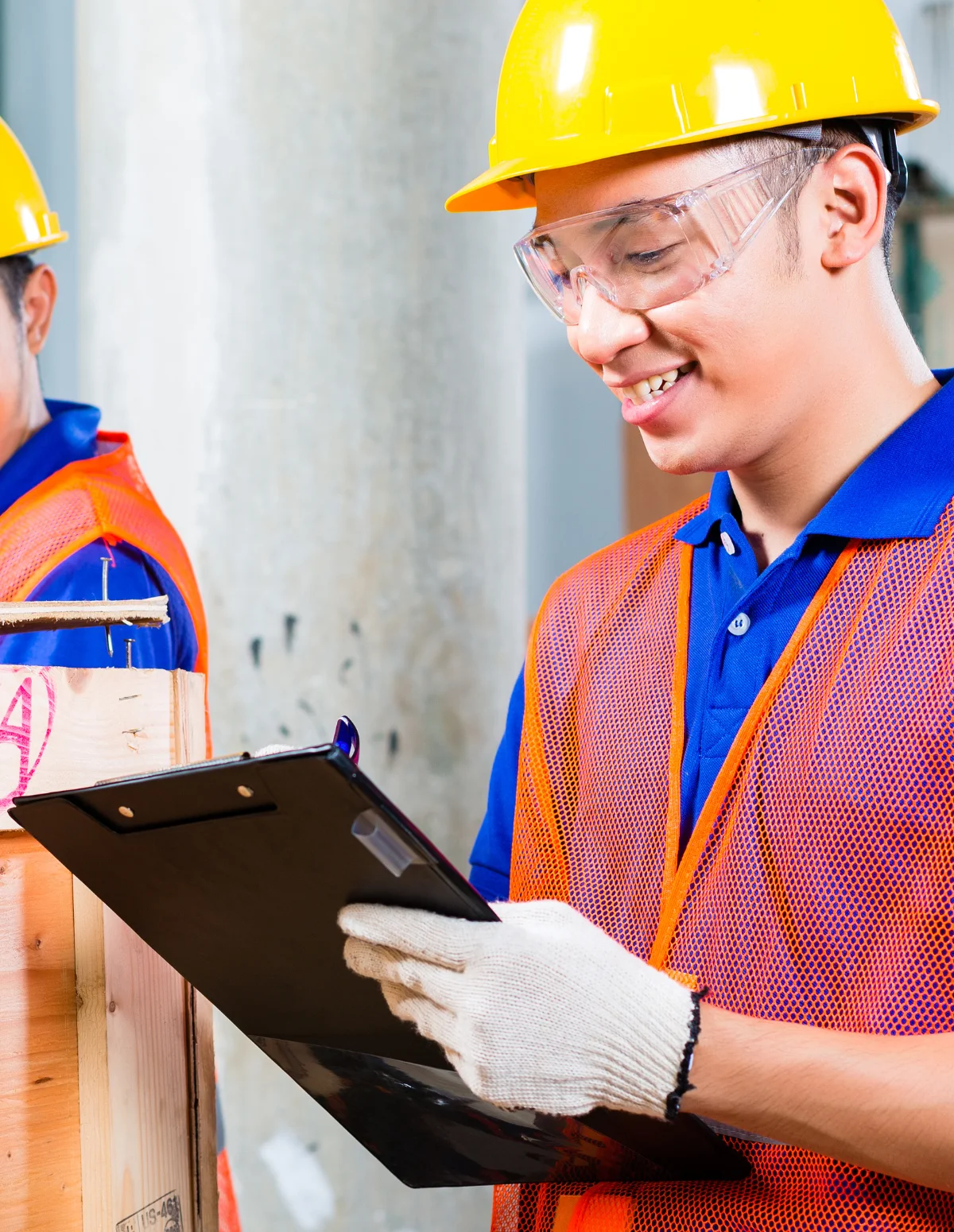 Construction worker writing on a clip board